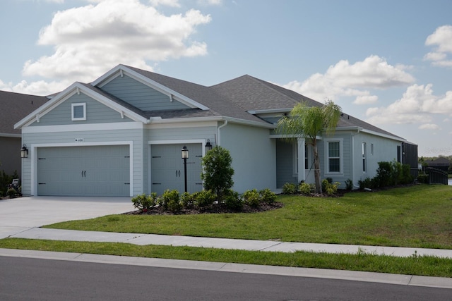 view of front of property with a front lawn and a garage