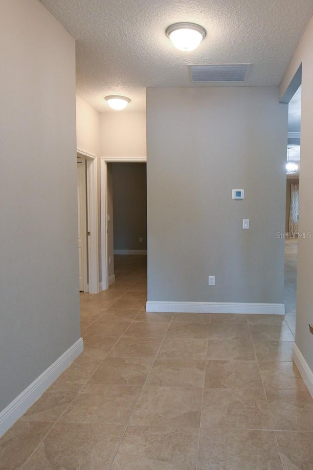 hall with a textured ceiling