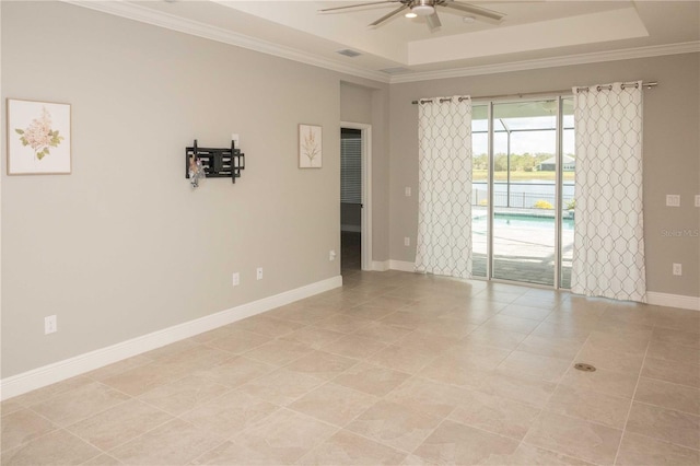 unfurnished room featuring a tray ceiling, ceiling fan, crown molding, and light tile patterned flooring