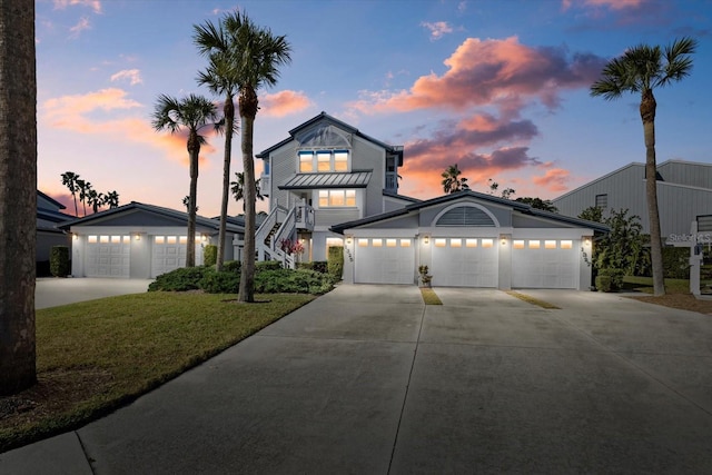 view of front facade with a yard and a garage