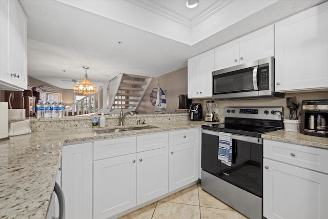 kitchen with sink, stainless steel appliances, white cabinetry, and kitchen peninsula