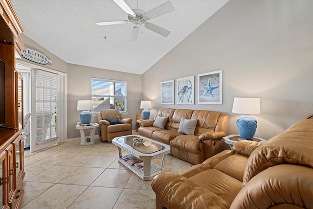 tiled living room featuring ceiling fan, vaulted ceiling, and a textured ceiling