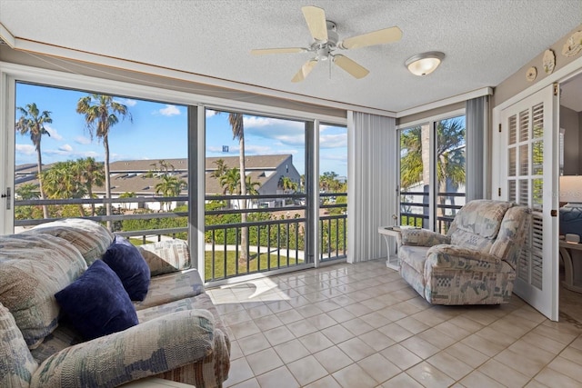 sunroom / solarium featuring ceiling fan