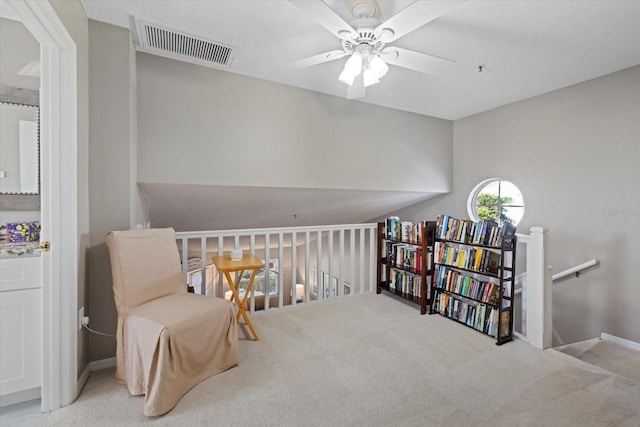 living area featuring ceiling fan and light carpet