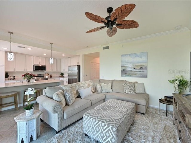 living room with ceiling fan and ornamental molding