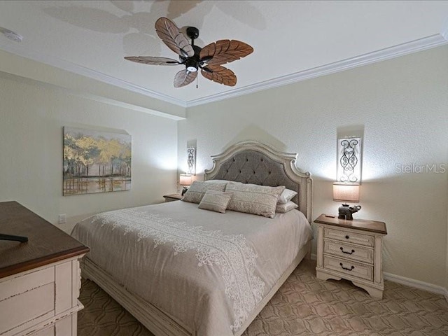 carpeted bedroom featuring ceiling fan and crown molding