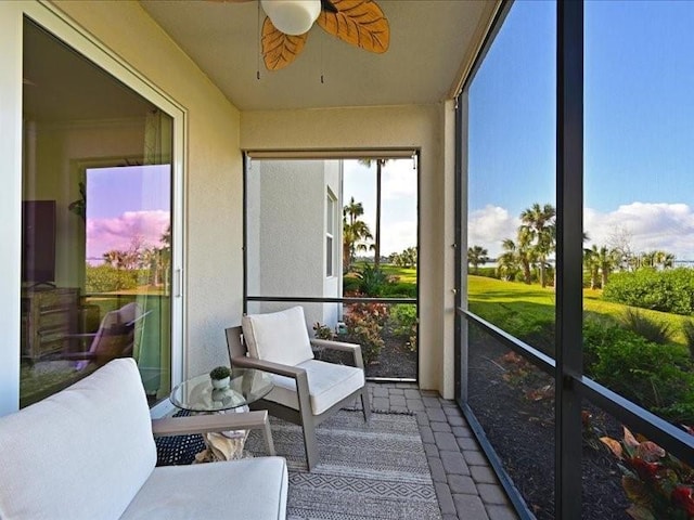 sunroom featuring ceiling fan