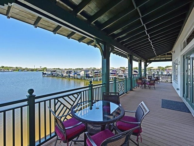 wooden terrace featuring a water view