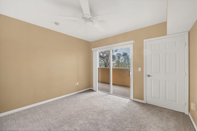 carpeted spare room with ceiling fan