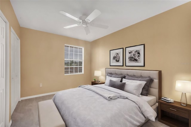 carpeted bedroom featuring a closet and ceiling fan