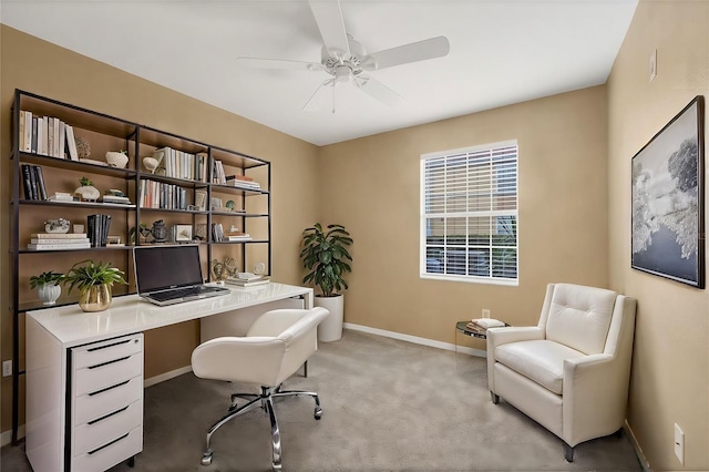 carpeted office space featuring ceiling fan