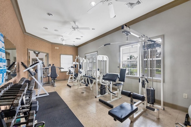 gym featuring plenty of natural light, ceiling fan, and crown molding