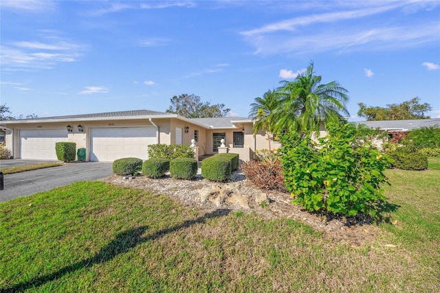 ranch-style home with a front lawn and a garage