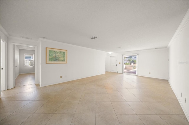 unfurnished room featuring crown molding, plenty of natural light, and light tile patterned floors