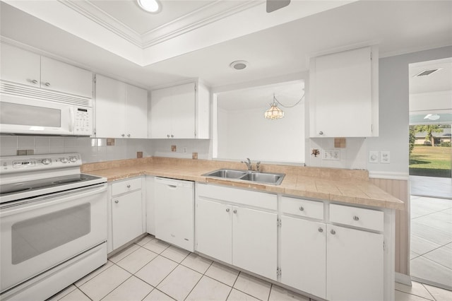 kitchen featuring sink, white cabinets, white appliances, ornamental molding, and hanging light fixtures