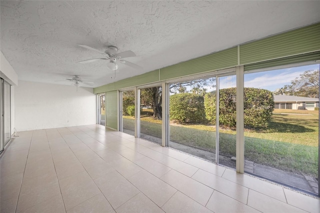 unfurnished sunroom with ceiling fan