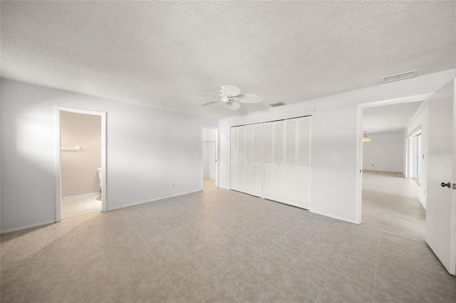 unfurnished bedroom featuring ensuite bathroom and ceiling fan