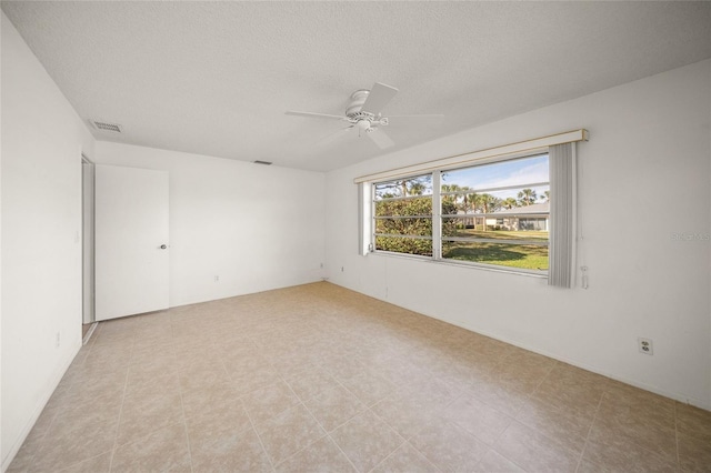 spare room featuring ceiling fan and a textured ceiling