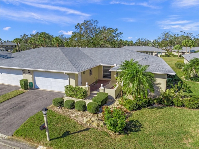 view of front of house featuring a garage and a front lawn