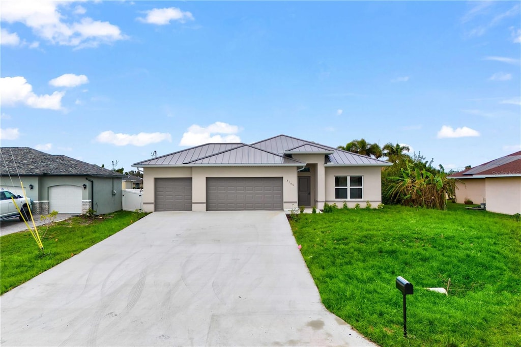 view of front of property with a garage and a front lawn