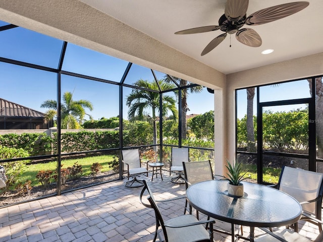 sunroom / solarium featuring ceiling fan