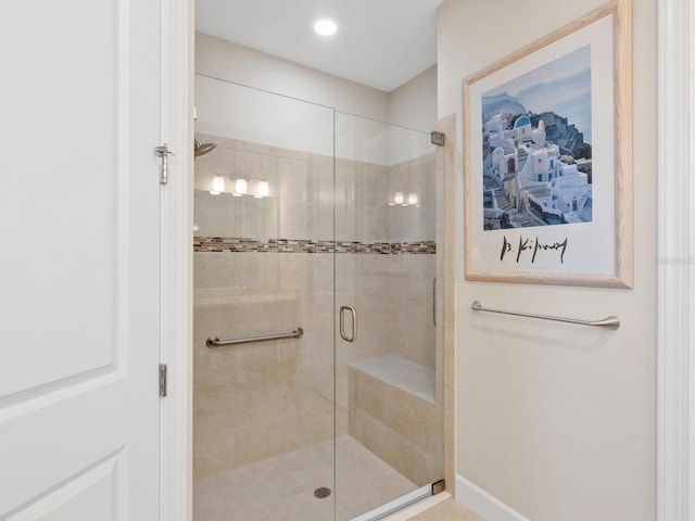 bathroom featuring a shower with door