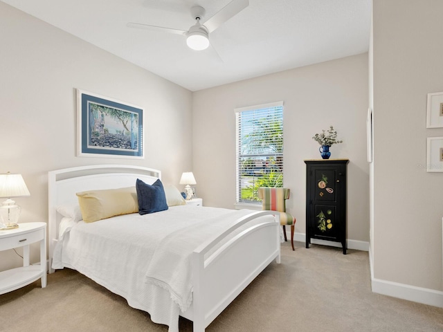 bedroom featuring light colored carpet and ceiling fan