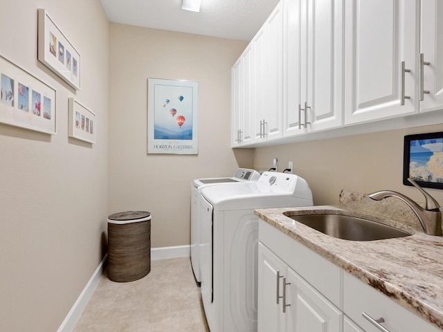 clothes washing area featuring cabinets, separate washer and dryer, and sink