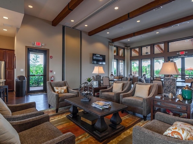 living room featuring beamed ceiling and a towering ceiling