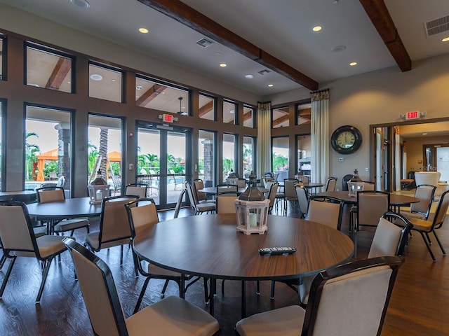 dining room featuring french doors, beamed ceiling, and dark wood-type flooring