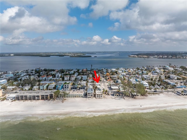 birds eye view of property featuring a beach view and a water view