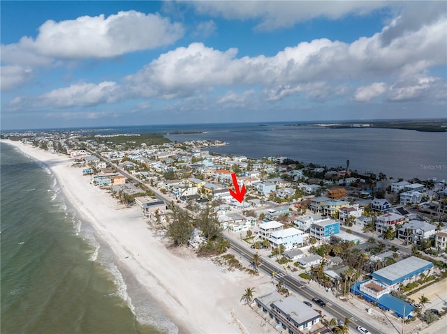 birds eye view of property with a beach view and a water view