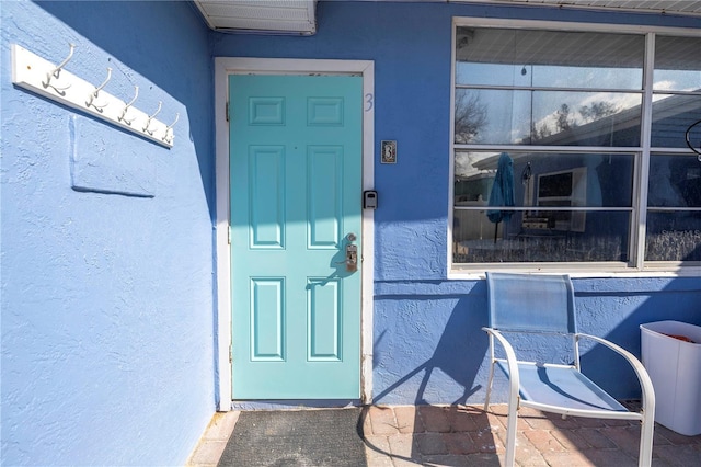 doorway to property featuring a wall mounted air conditioner