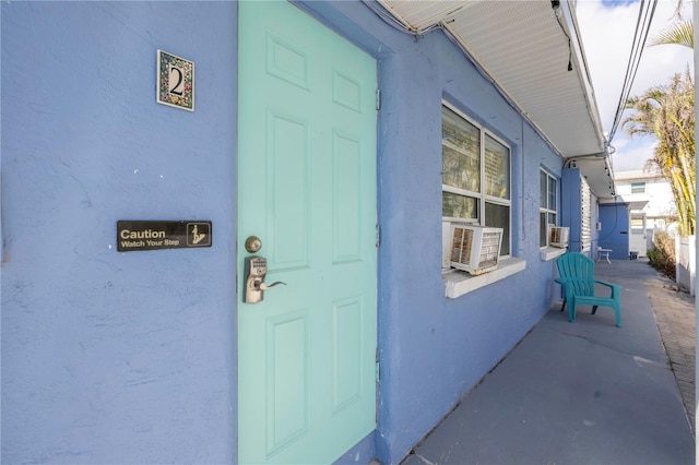 doorway to property featuring cooling unit