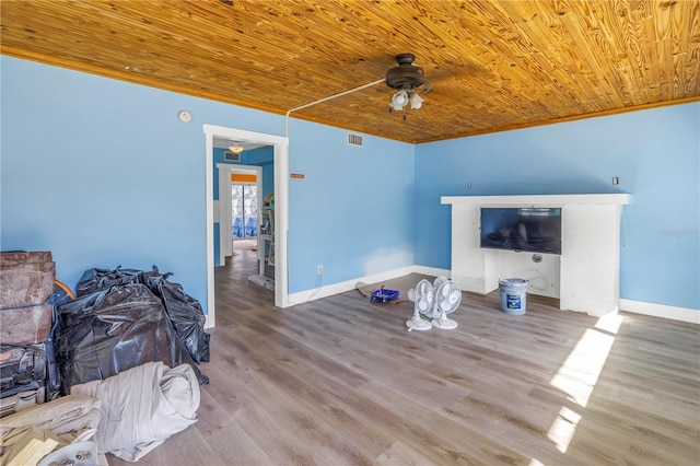 living room featuring ceiling fan, light hardwood / wood-style flooring, wood ceiling, and ornamental molding