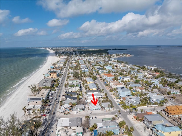 drone / aerial view featuring a beach view and a water view