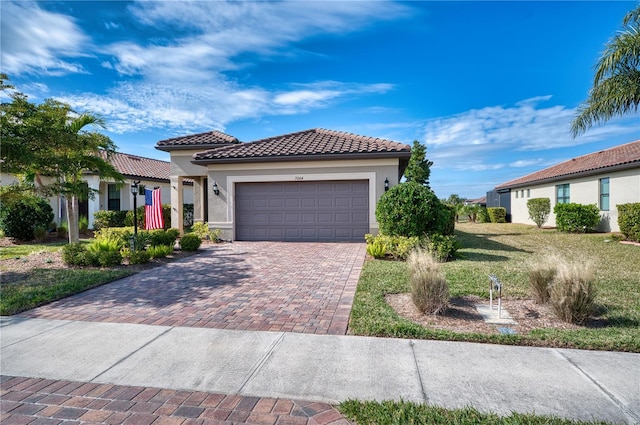 mediterranean / spanish-style home with a front yard and a garage