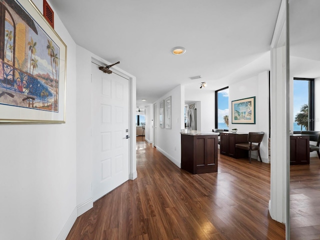 hallway with dark hardwood / wood-style flooring