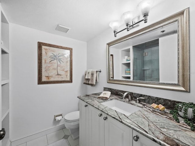 bathroom with toilet, vanity, tile patterned floors, and an enclosed shower