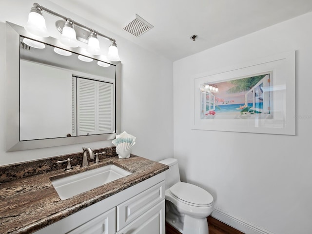 bathroom featuring hardwood / wood-style flooring, vanity, and toilet