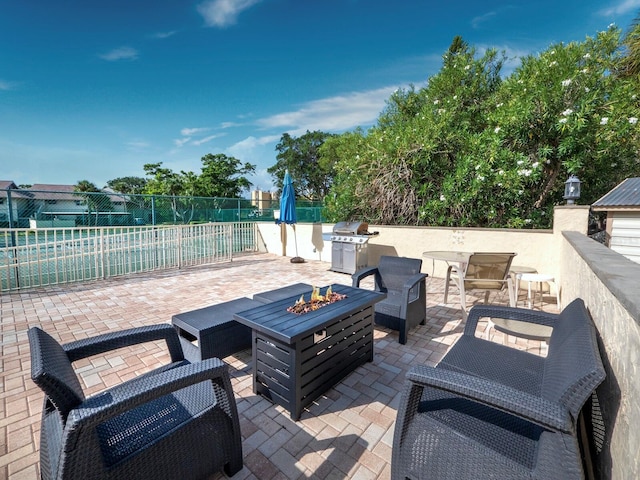 view of patio featuring a fire pit and a grill