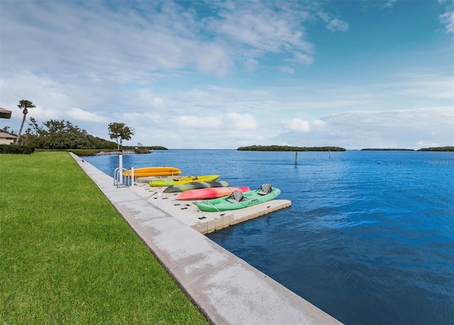 view of dock featuring a lawn and a water view