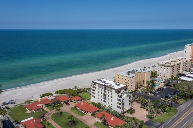 birds eye view of property featuring a beach view and a water view