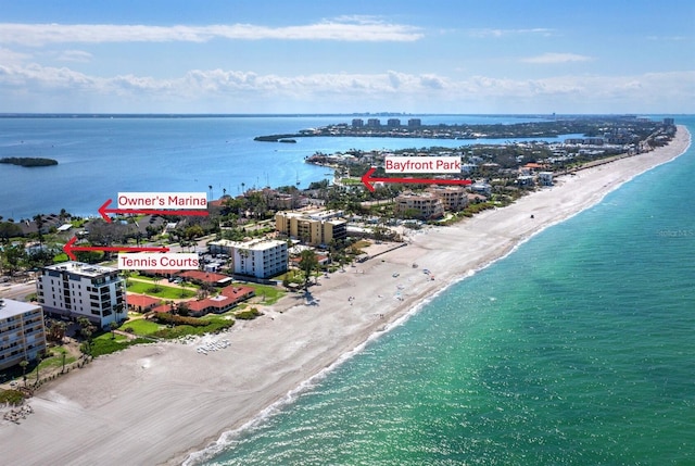birds eye view of property featuring a city view, a view of the beach, and a water view