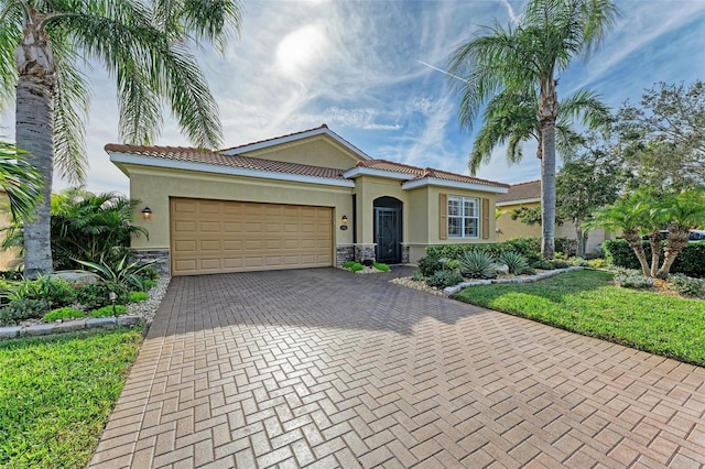 mediterranean / spanish house with a garage and a front lawn