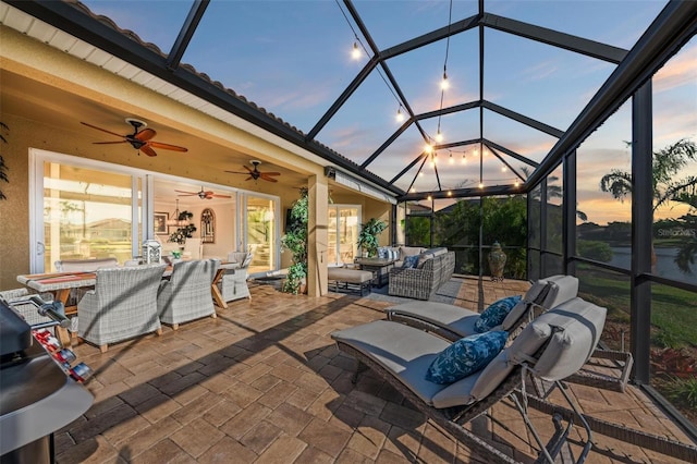 patio terrace at dusk featuring a lanai