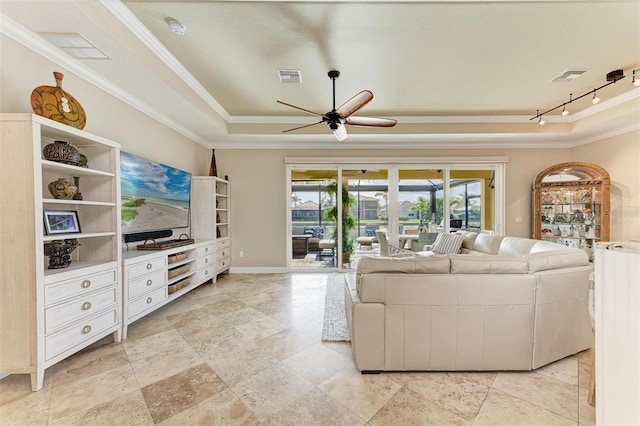 living room with a raised ceiling, ceiling fan, track lighting, and ornamental molding