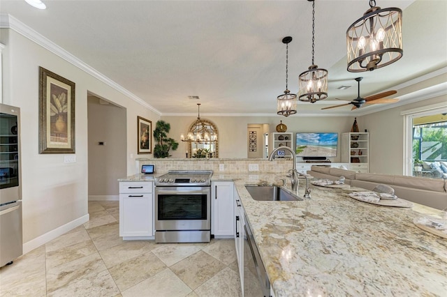 kitchen with pendant lighting, sink, ceiling fan, white cabinetry, and stainless steel appliances