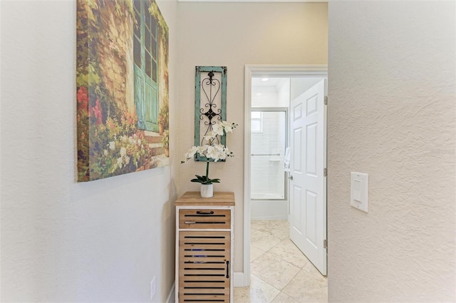 corridor featuring light tile patterned floors