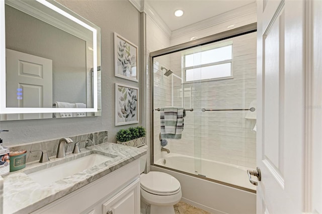 full bathroom featuring shower / bath combination with glass door, vanity, ornamental molding, and toilet